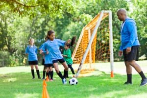 coach teaching soccer drills