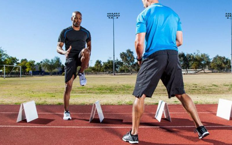 man doing speed agility training on a track