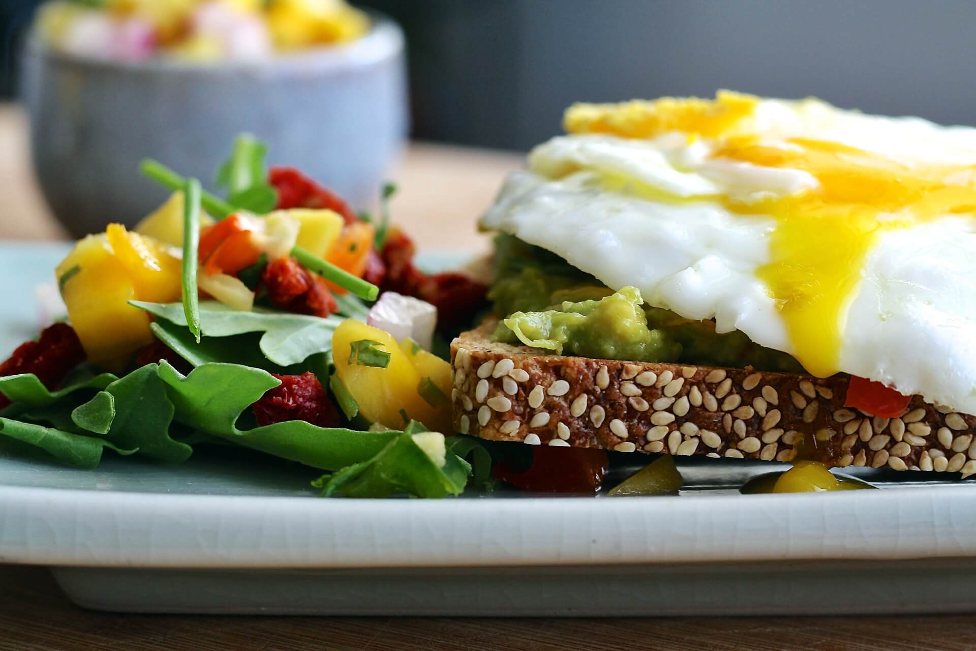a plate of eggs, greens, and toast
