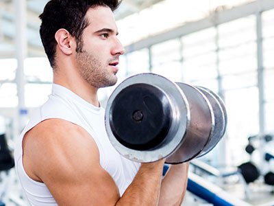 man working on hypertrophy with bicep curls
