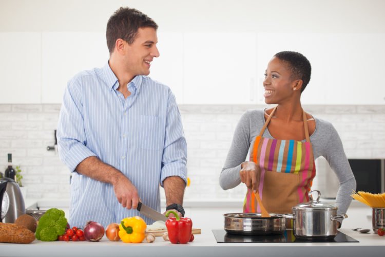 two vegan trainers making healthy plant-based meals in the kitchen