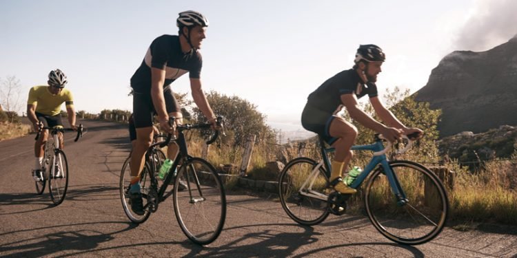 Two cyclists riding bikes