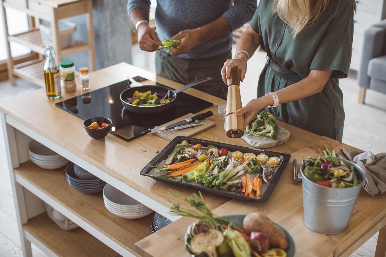 trainers helping a client change nutrition habits in kitchen