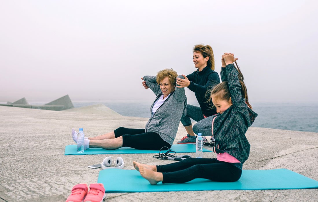 senior and youth doing yoga stretches