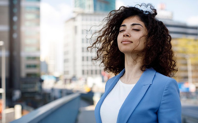 peaceful woman outside practicing self care