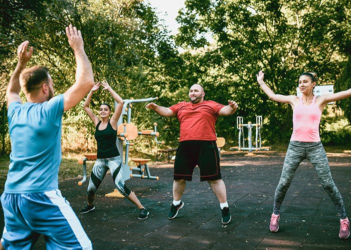 trainer doing exercises with clients for weight loss