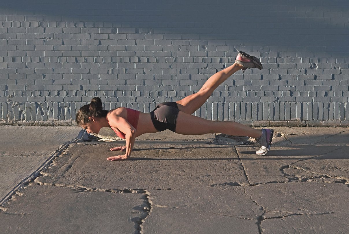 Woman doing a pushup outdoors